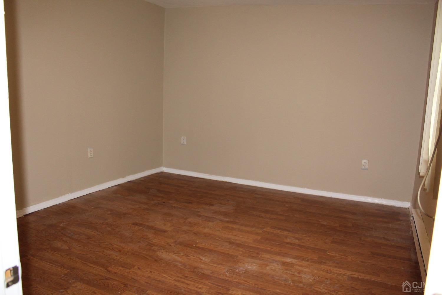 27 Markham Road Edison, NJ 08817 - Photo 6 of 28 a view of an empty room with wooden floor