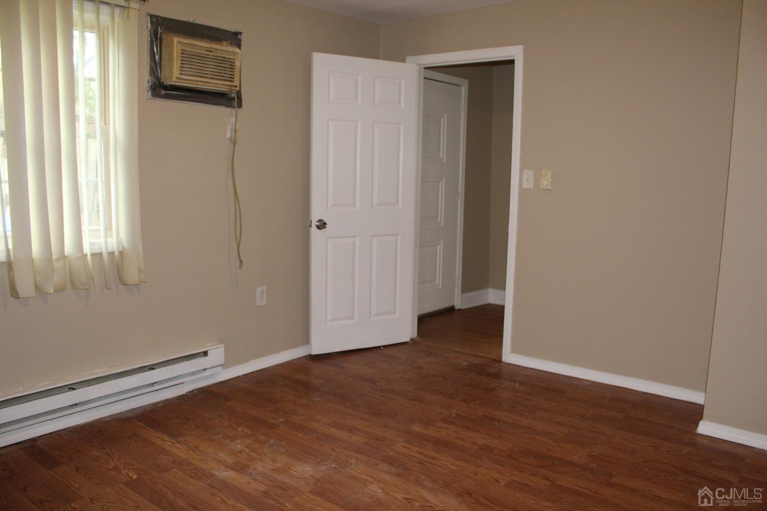 27 Markham Road Edison, NJ 08817 - Photo 8 of 28 a view of an empty room with wooden floor and a window