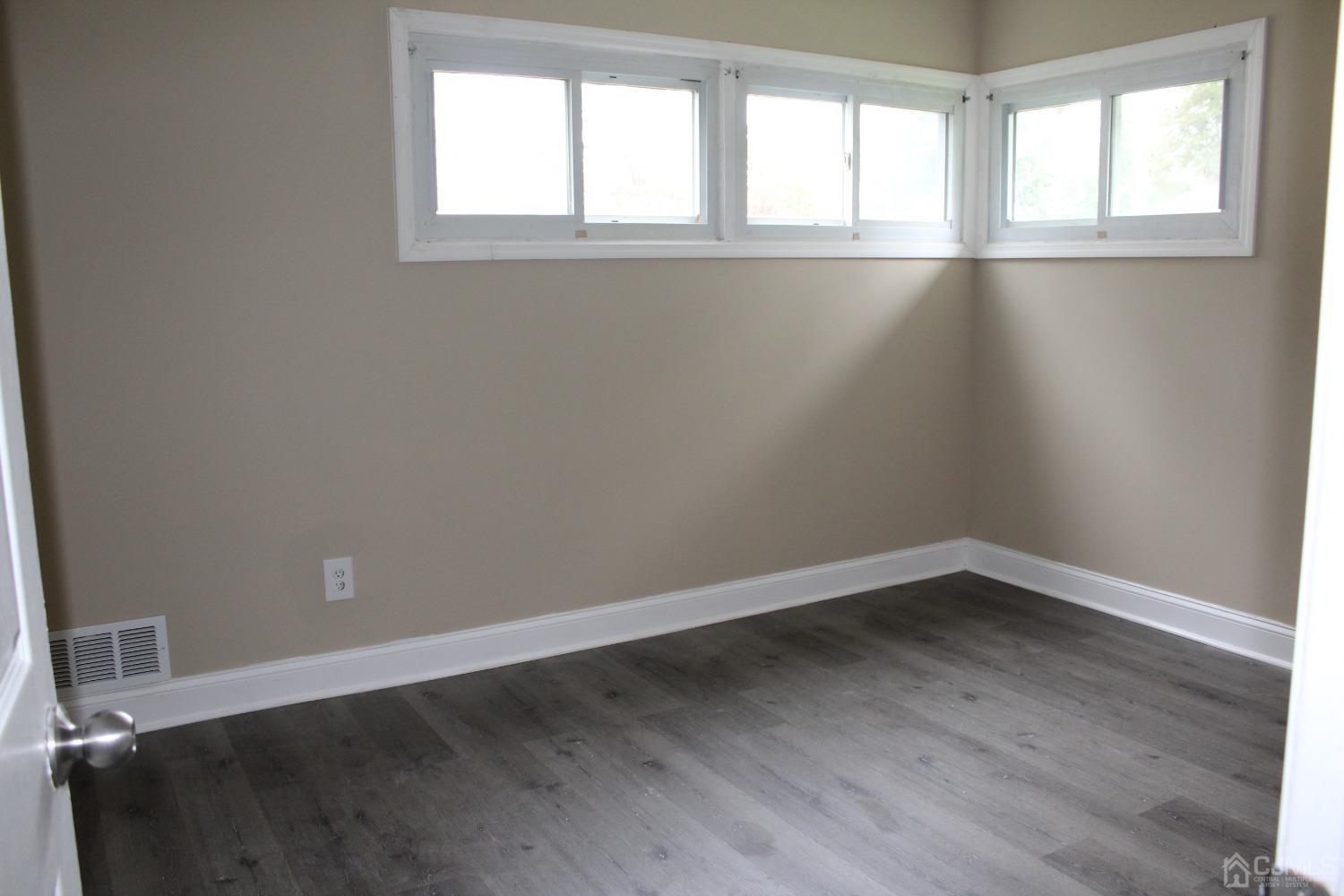 27 Markham Road Edison, NJ 08817 - Photo 9 of 28 an empty room with wooden floor and windows