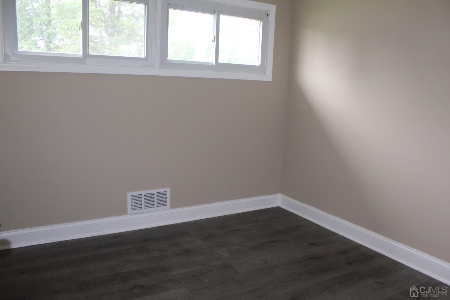 27 Markham Road Edison, NJ 08817 - Photo 10 of 28 an empty room with wooden floor and windows