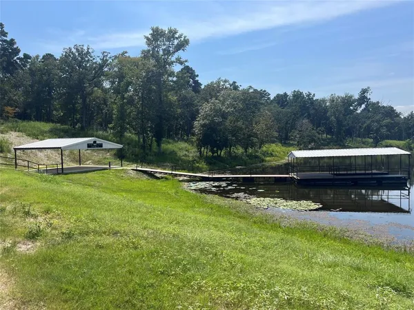 a view of a lake with a table and a chairs