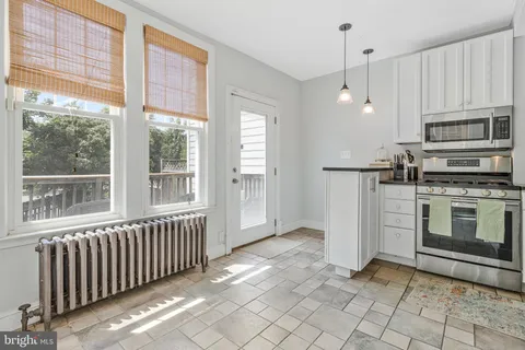 a view of kitchen with sink oven and window