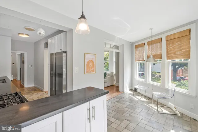 a kitchen with stainless steel appliances kitchen island granite countertop a refrigerator and a sink