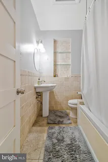 a bathroom with a sink a toilet and bathtub