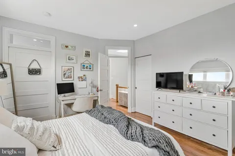 a bedroom with a bed and a flat screen tv in it