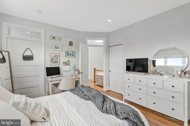 a bedroom with a bed and a flat screen tv in it
