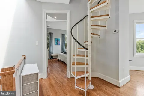 a view of entryway with wooden floor and stairs