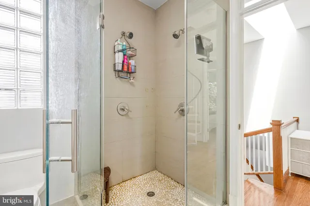 a bathroom with a shower and a sink