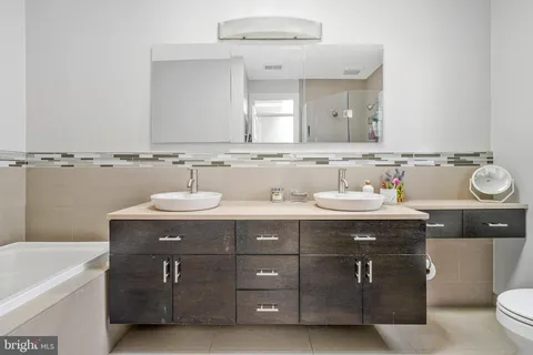 a bathroom with a sink double vanity and a mirror