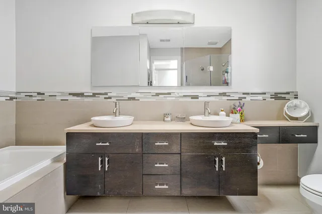 a bathroom with a sink double vanity and a mirror