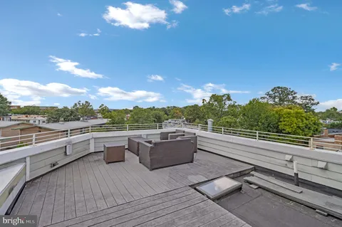 a view of a terrace with couches and sky view