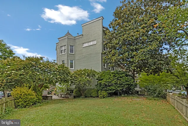 a backyard of a house with outdoor seating