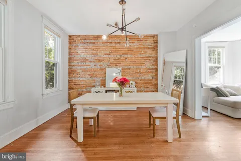 a view of a dining room with furniture wooden floor and a chandelier