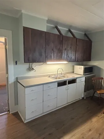 a kitchen with sink cabinets and window