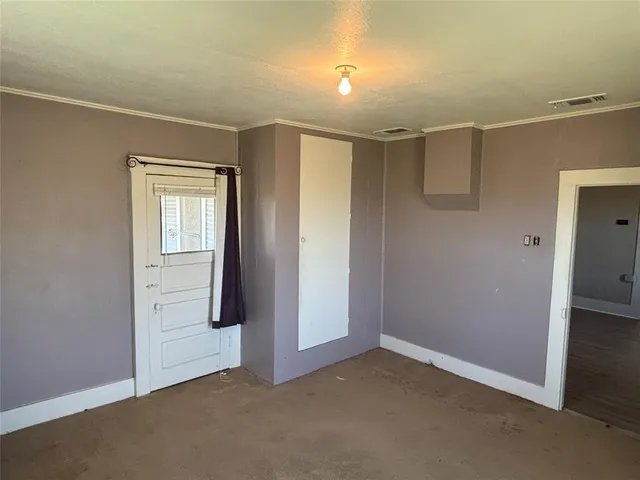 an empty room with windows and closet