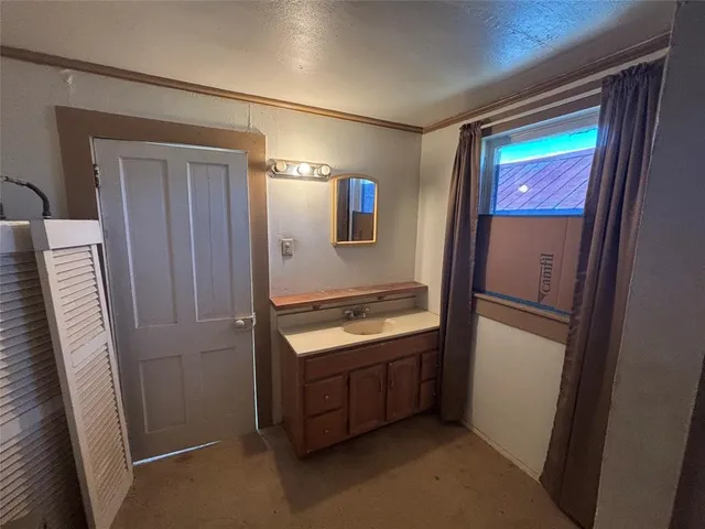 a room with window and refrigerator