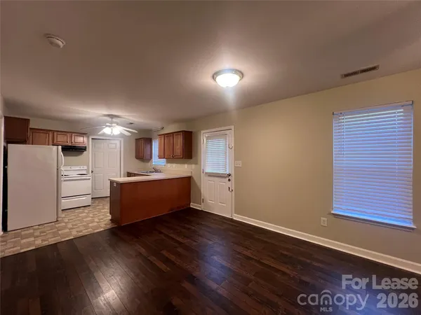 a large room with wooden floor and windows