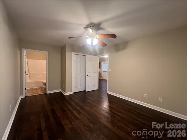 a view of an empty room and wooden floor