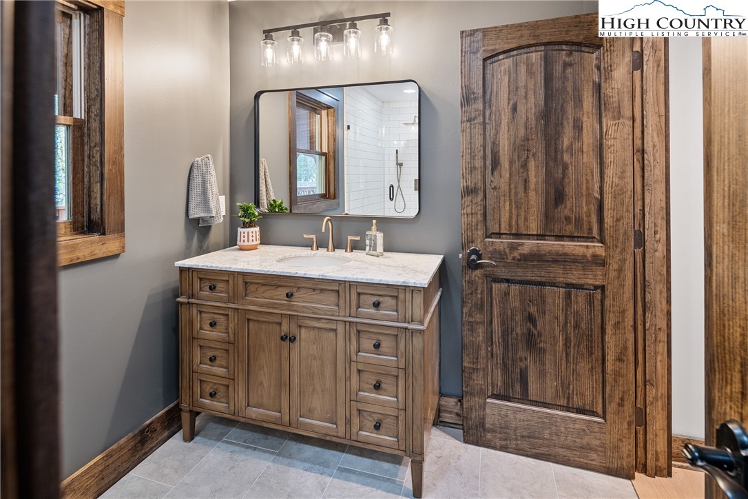 264 Foggy Lane Boone, NC 28607 - Photo 16 of 32 a bathroom with a sink vanity and a mirror