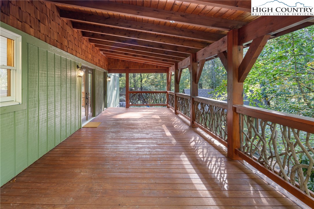 264 Foggy Lane Boone, NC 28607 - Photo 23 of 32 a porch with wooden floor in front of a house