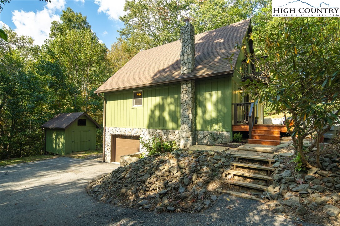 264 Foggy Lane Boone, NC 28607 - Photo 26 of 32 a front view of a house with garden