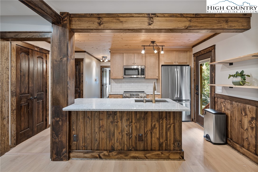 264 Foggy Lane Boone, NC 28607 - Photo 5 of 32 a kitchen with kitchen island granite countertop lots of counter top space and stainless steel appliances
