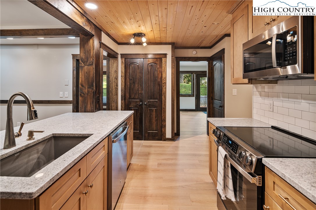 264 Foggy Lane Boone, NC 28607 - Photo 6 of 32 a kitchen with stainless steel appliances granite countertop a sink and a stove