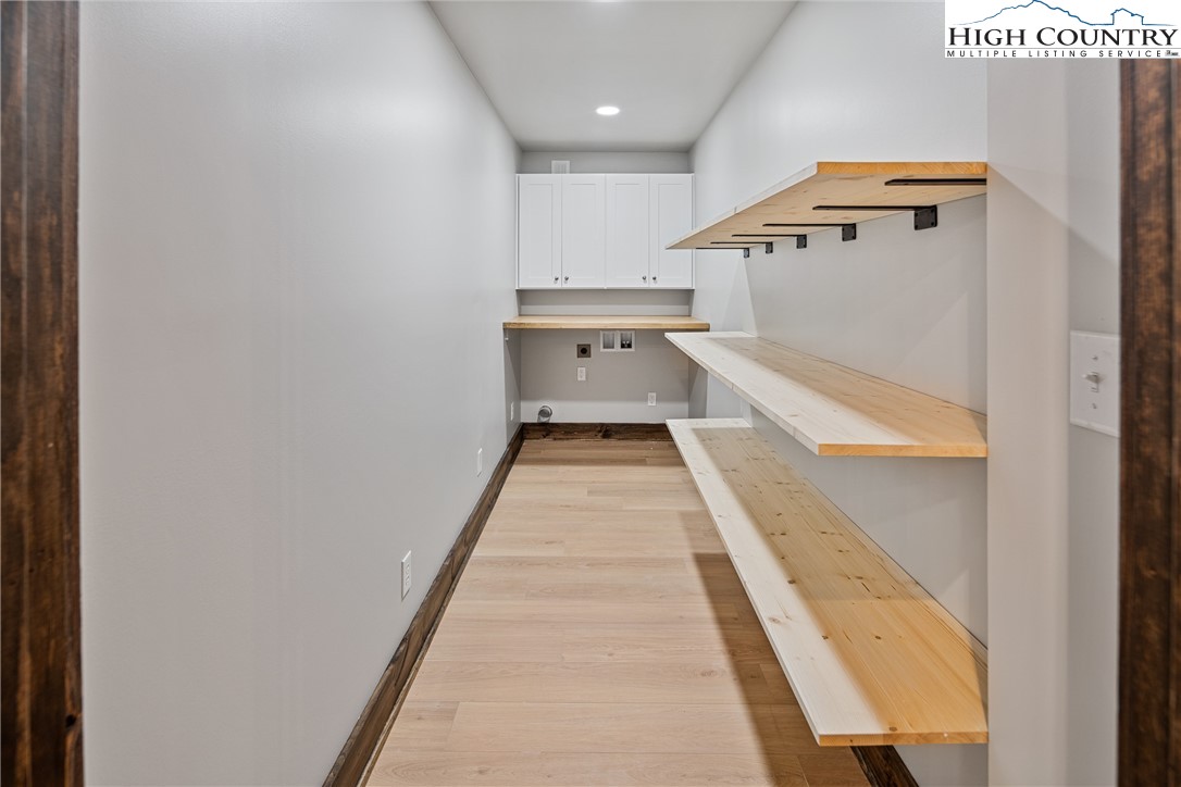 264 Foggy Lane Boone, NC 28607 - Photo 10 of 32 a hallway with stairs and wooden floor