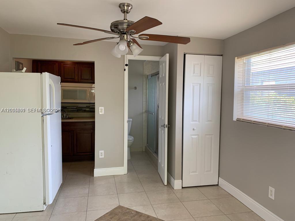 6012 Southwest 38th Street, Unit 4 Miramar, FL 33023 - Photo 2 of 7 a view of a kitchen with a refrigerator and a ceiling fan
