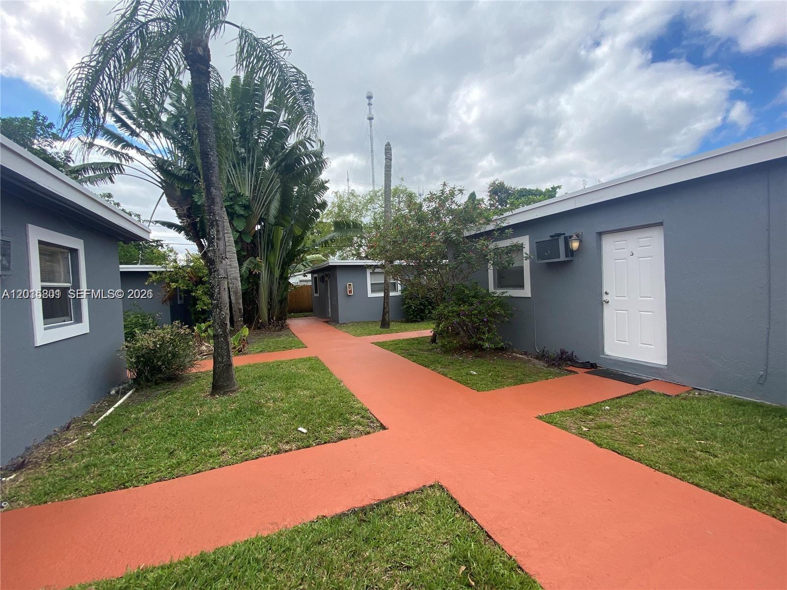 6012 Southwest 38th Street, Unit 4 Miramar, FL 33023 - Photo 6 of 7 a view of a backyard with potted plants and large trees