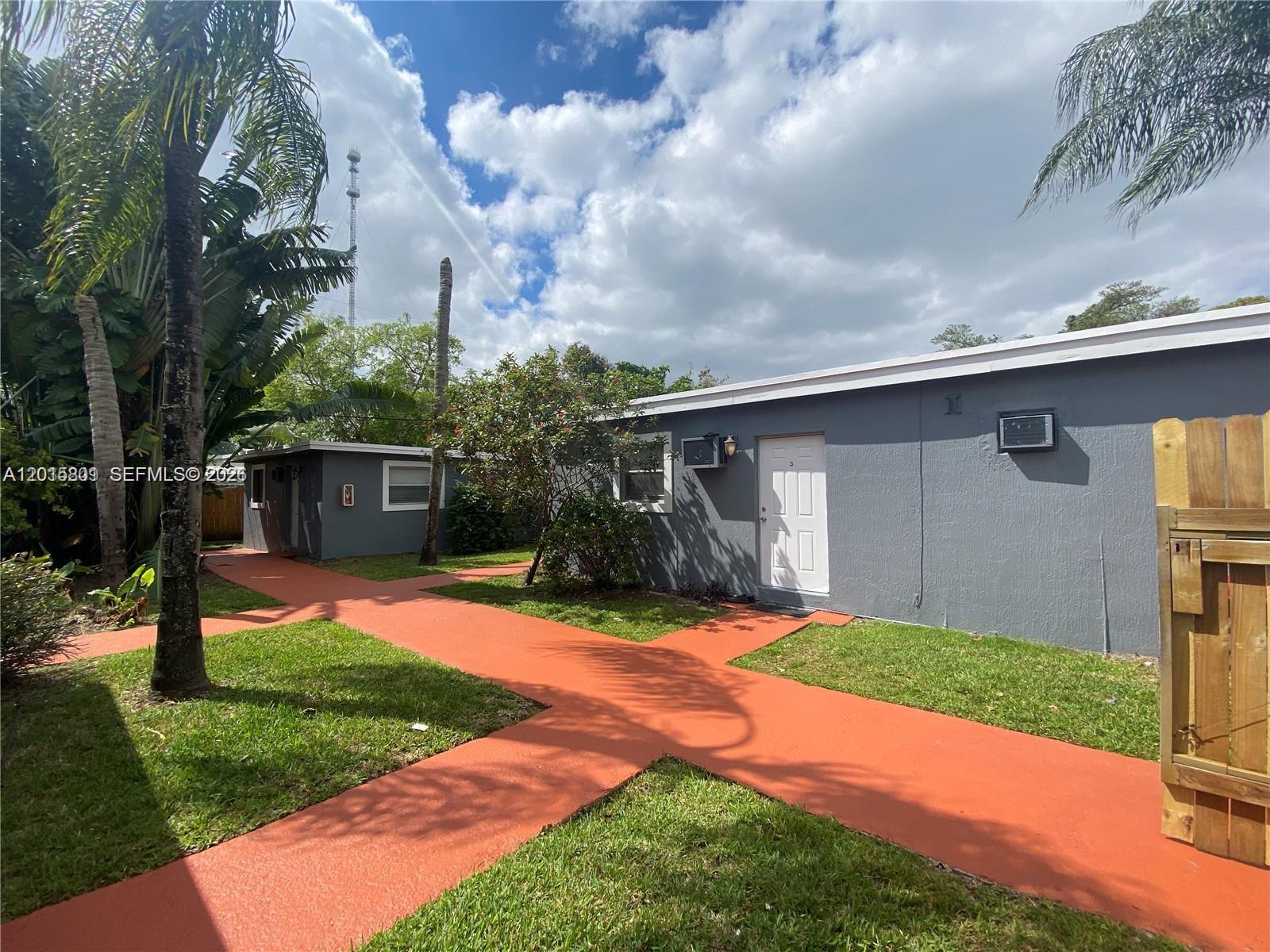 6012 Southwest 38th Street, Unit 4 Miramar, FL 33023 - Photo 7 of 7 a front view of a house with a yard and garage