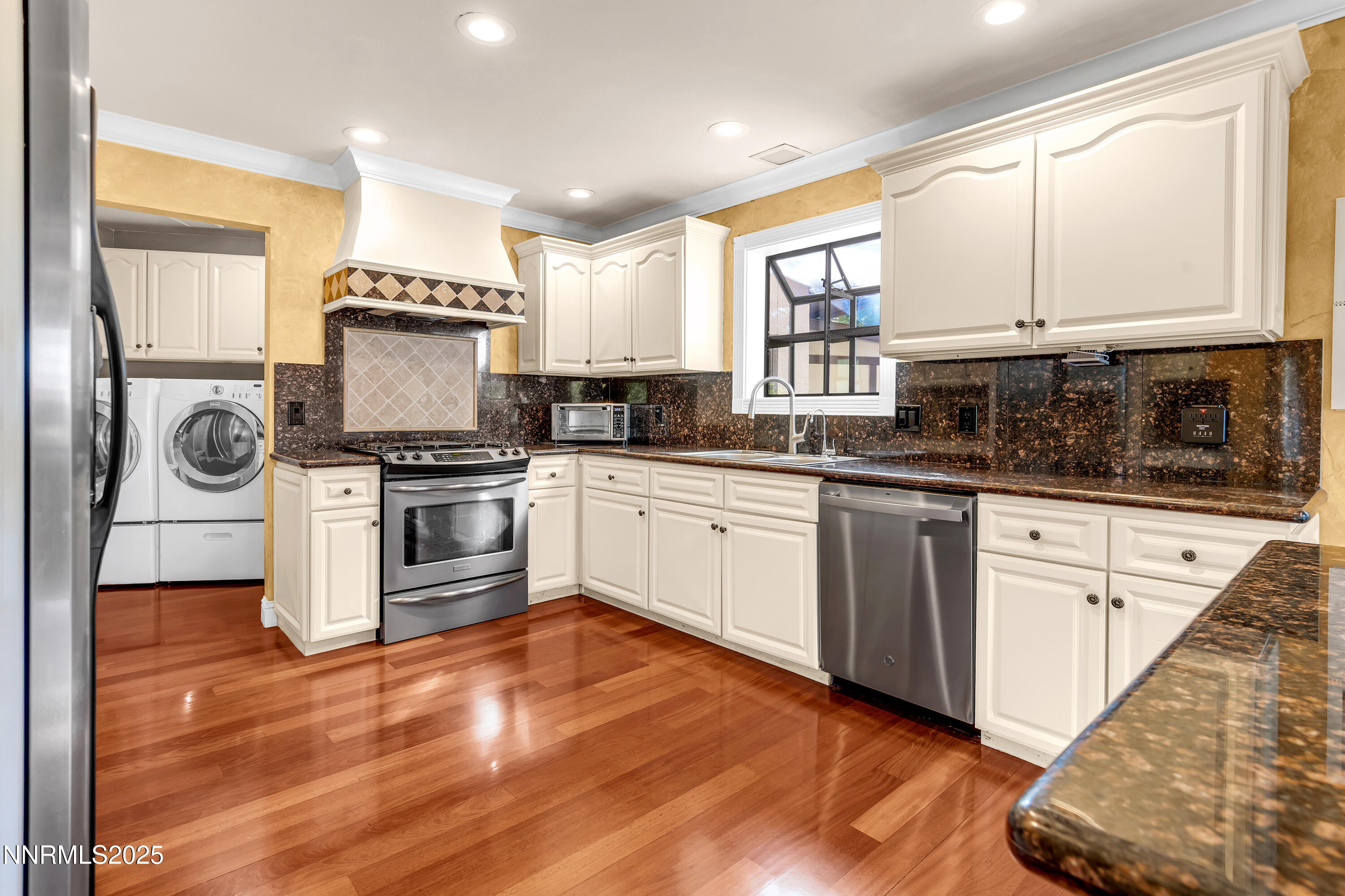 2835 Parkway Drive Reno, NV 89502 - Photo 11 of 39 a kitchen with white cabinets stainless steel appliances and sink