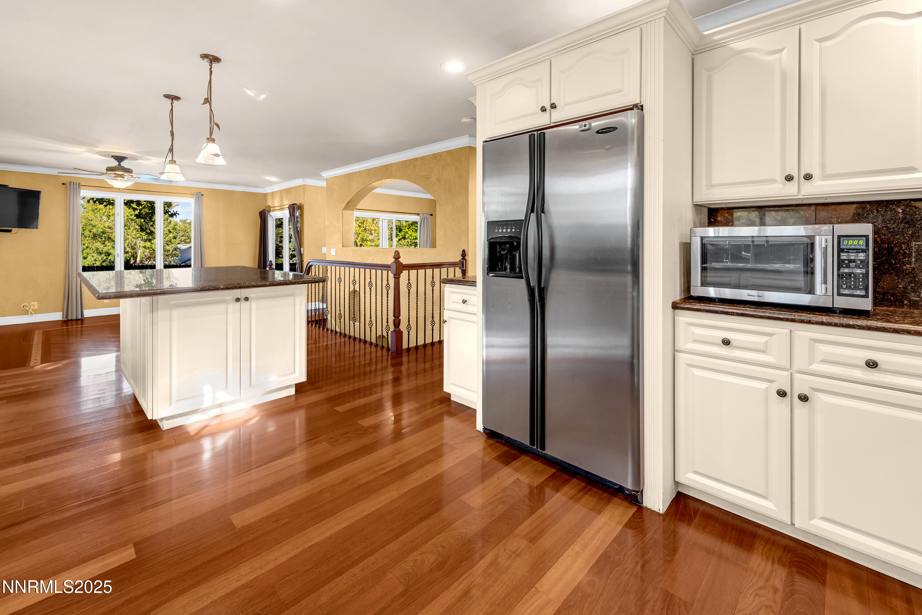 2835 Parkway Drive Reno, NV 89502 - Photo 12 of 39 a kitchen with stainless steel appliances granite countertop a refrigerator a stove and white cabinets with wooden floors