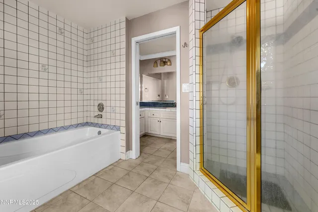 a bathroom with a bathtub and a shower