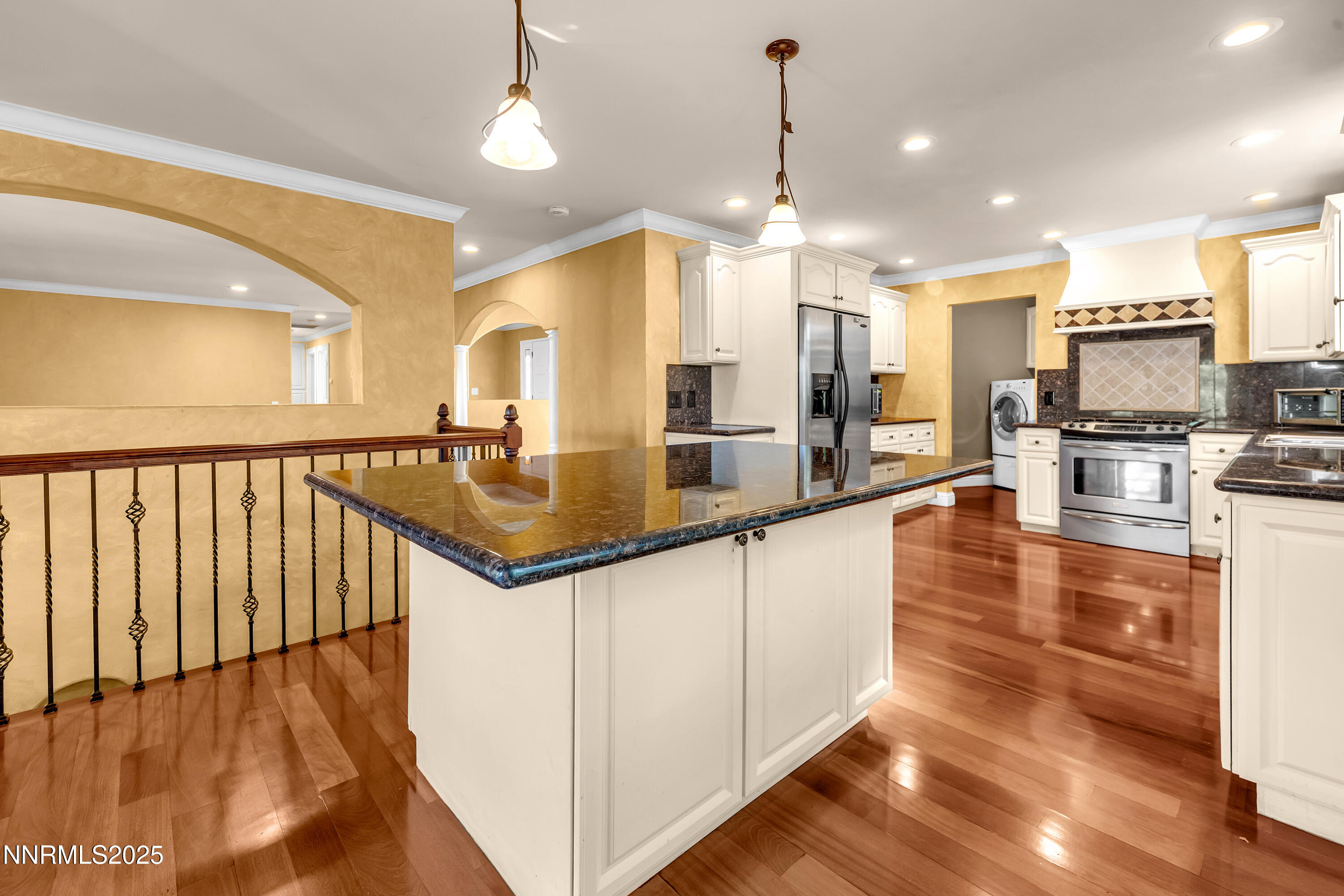 2835 Parkway Drive Reno, NV 89502 - Photo 9 of 39 a large kitchen with kitchen island a large counter top space a sink stainless steel appliances and cabinets