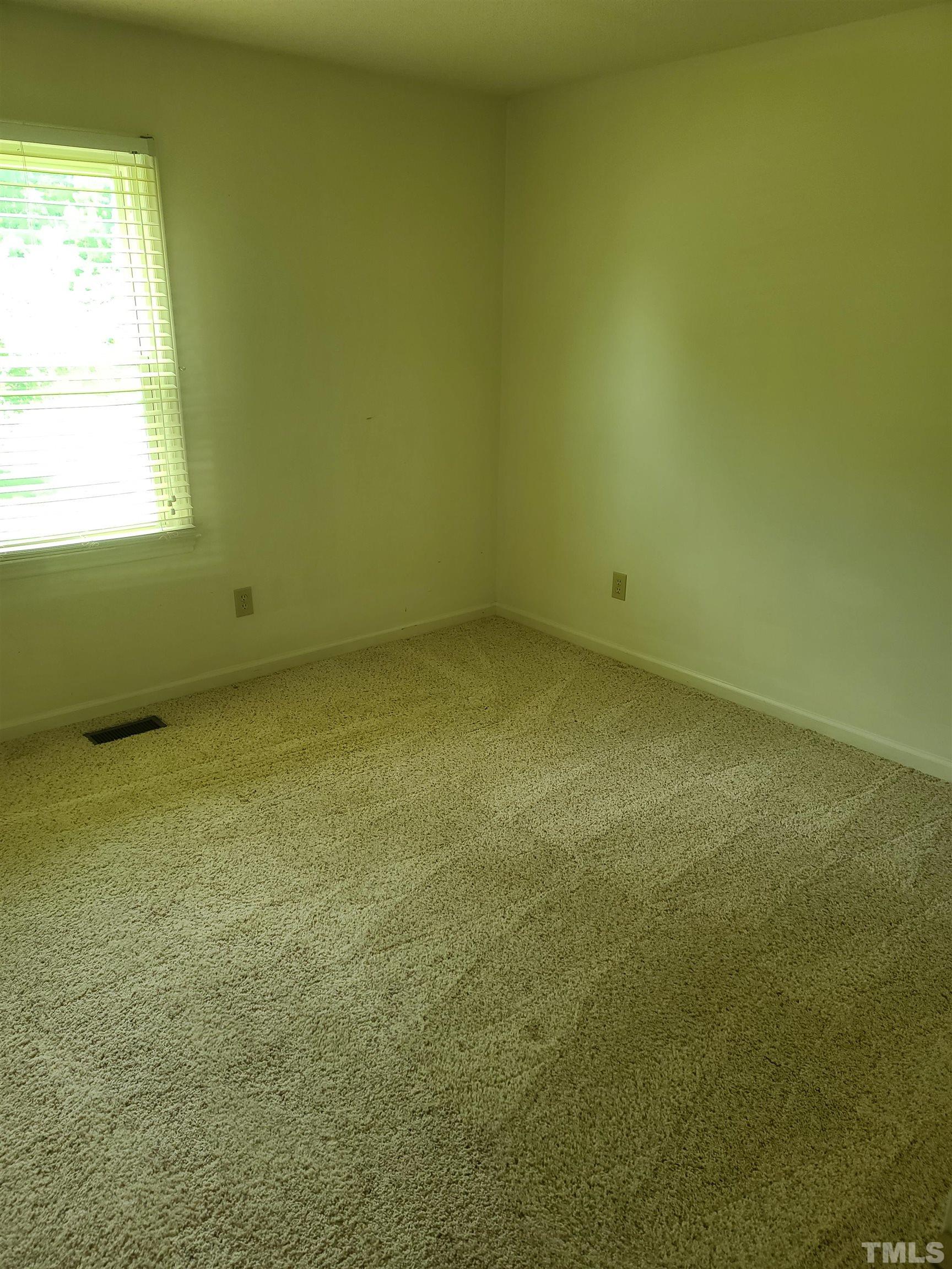 13125 Callens Lane Willow Spring, NC 27592 - Photo 11 of 13 a view of an empty room with a window