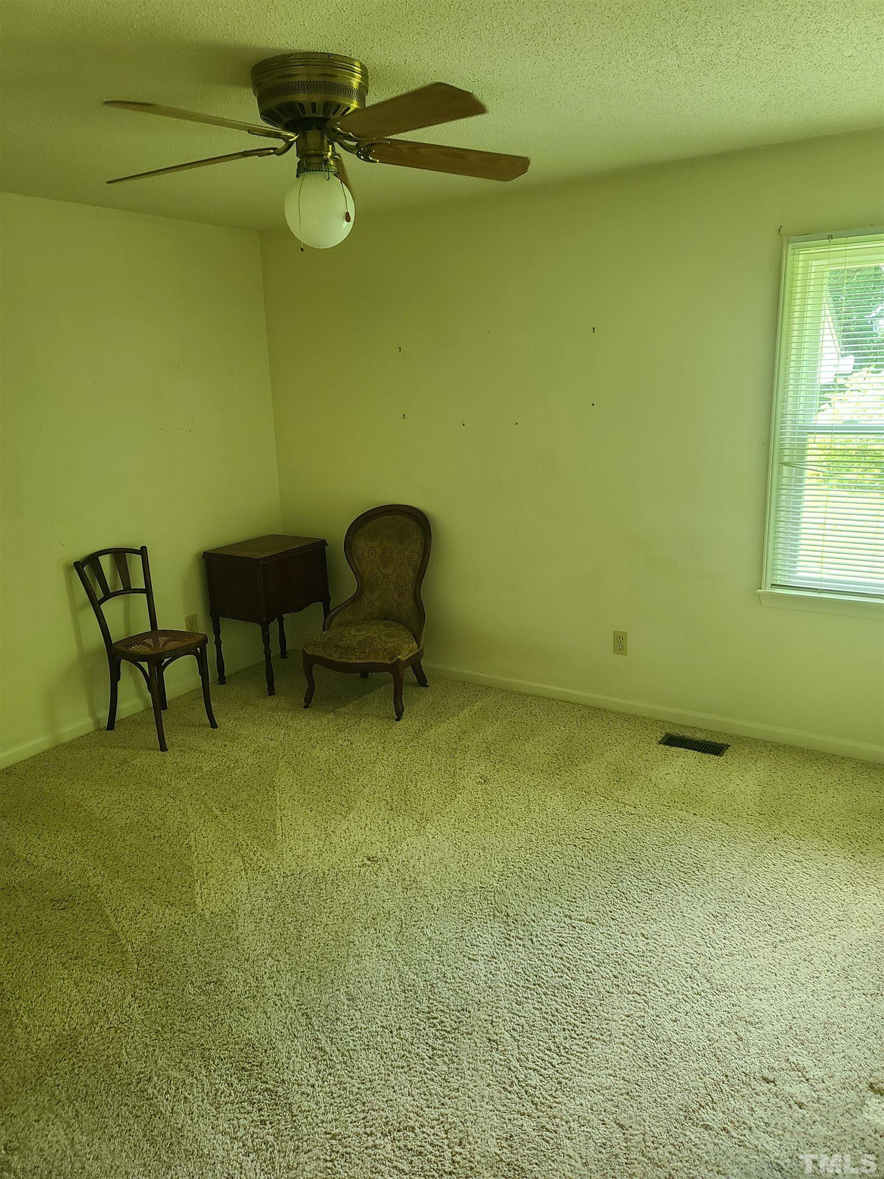 13125 Callens Lane Willow Spring, NC 27592 - Photo 12 of 13 a view of an empty room with windows