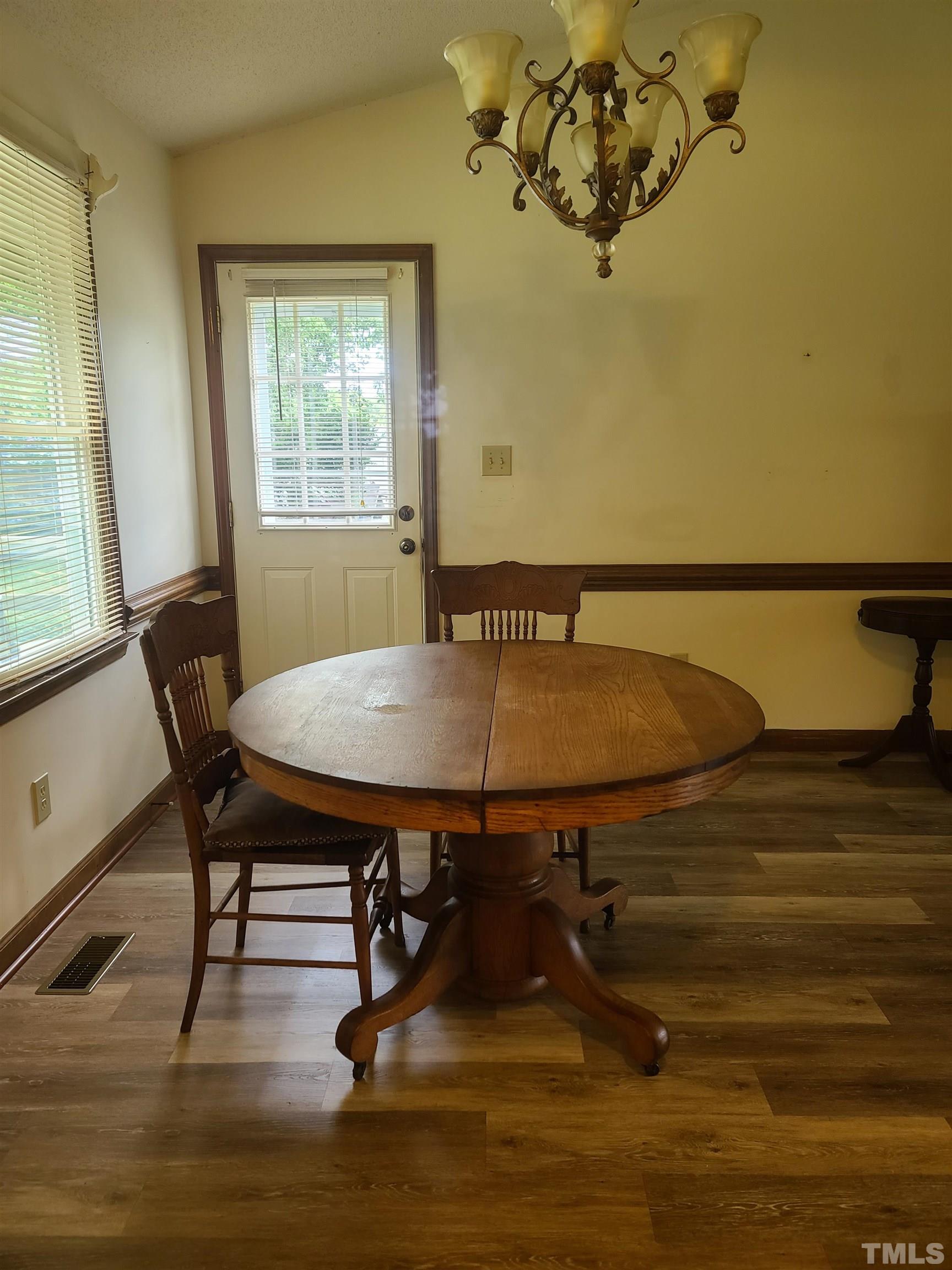 13125 Callens Lane Willow Spring, NC 27592 - Photo 6 of 13 a view of a dining room with furniture and window
