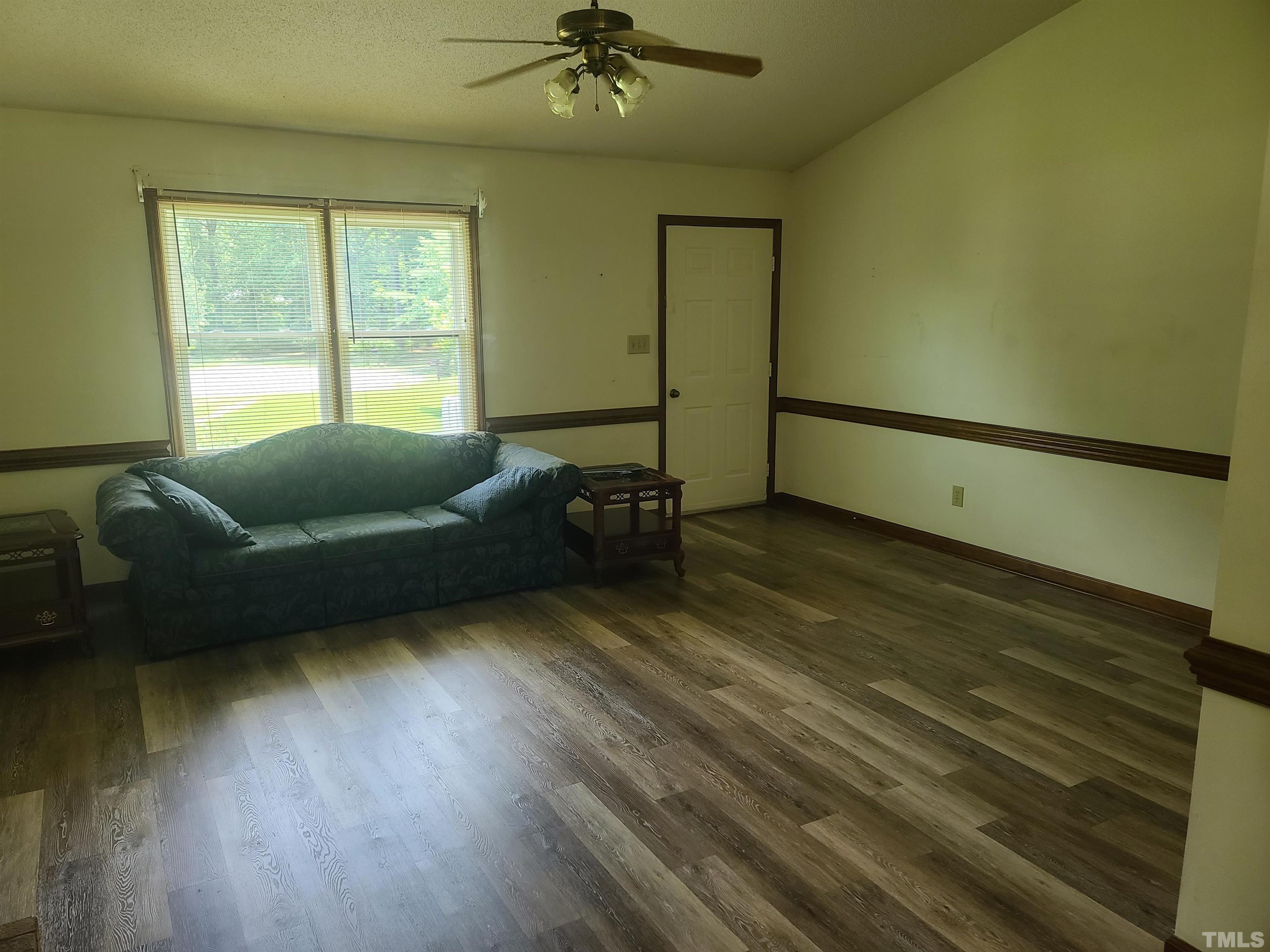 13125 Callens Lane Willow Spring, NC 27592 - Photo 7 of 13 a living room with furniture and a wooden floor