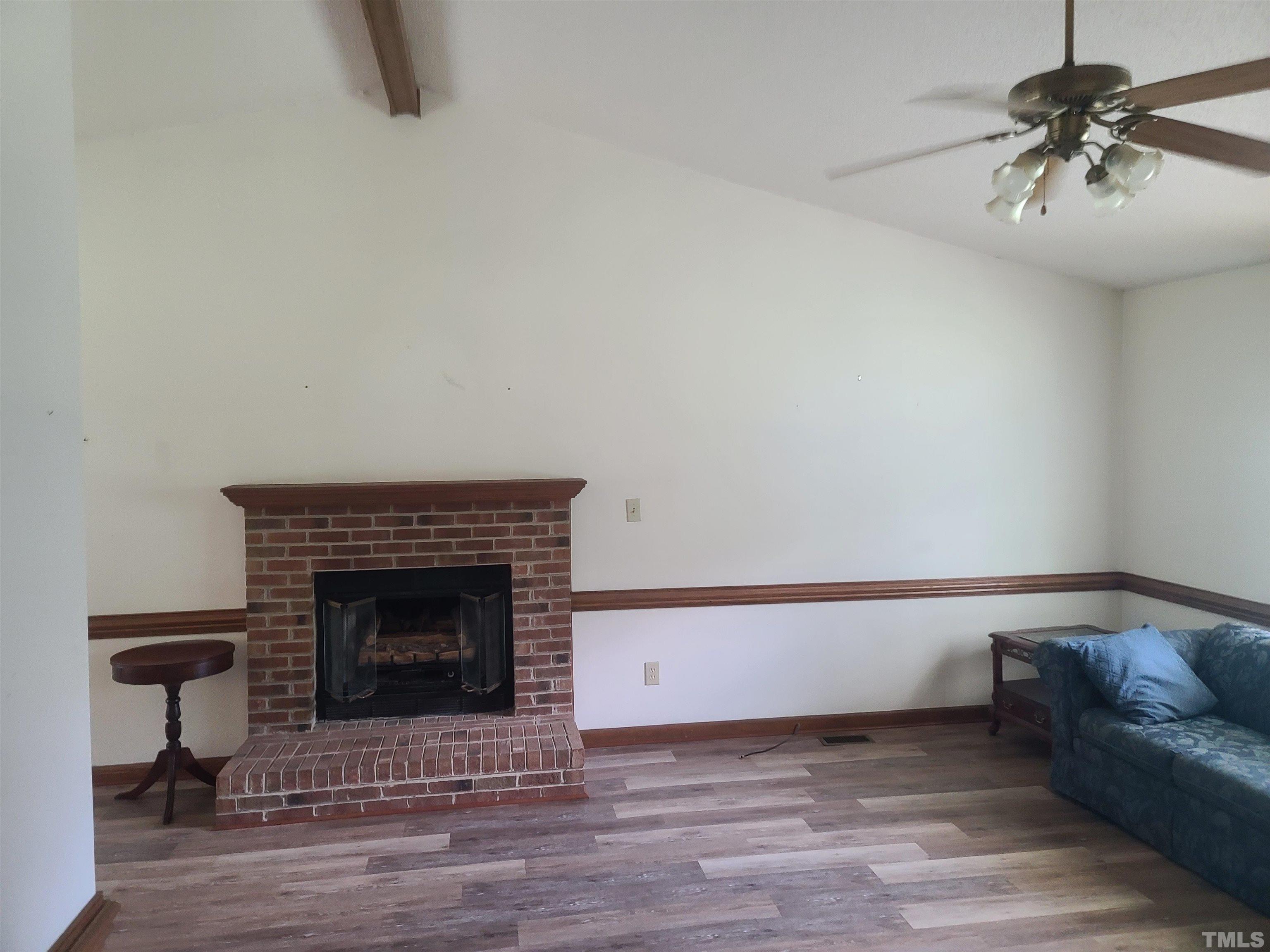 13125 Callens Lane Willow Spring, NC 27592 - Photo 8 of 13 a living room with furniture and a fireplace