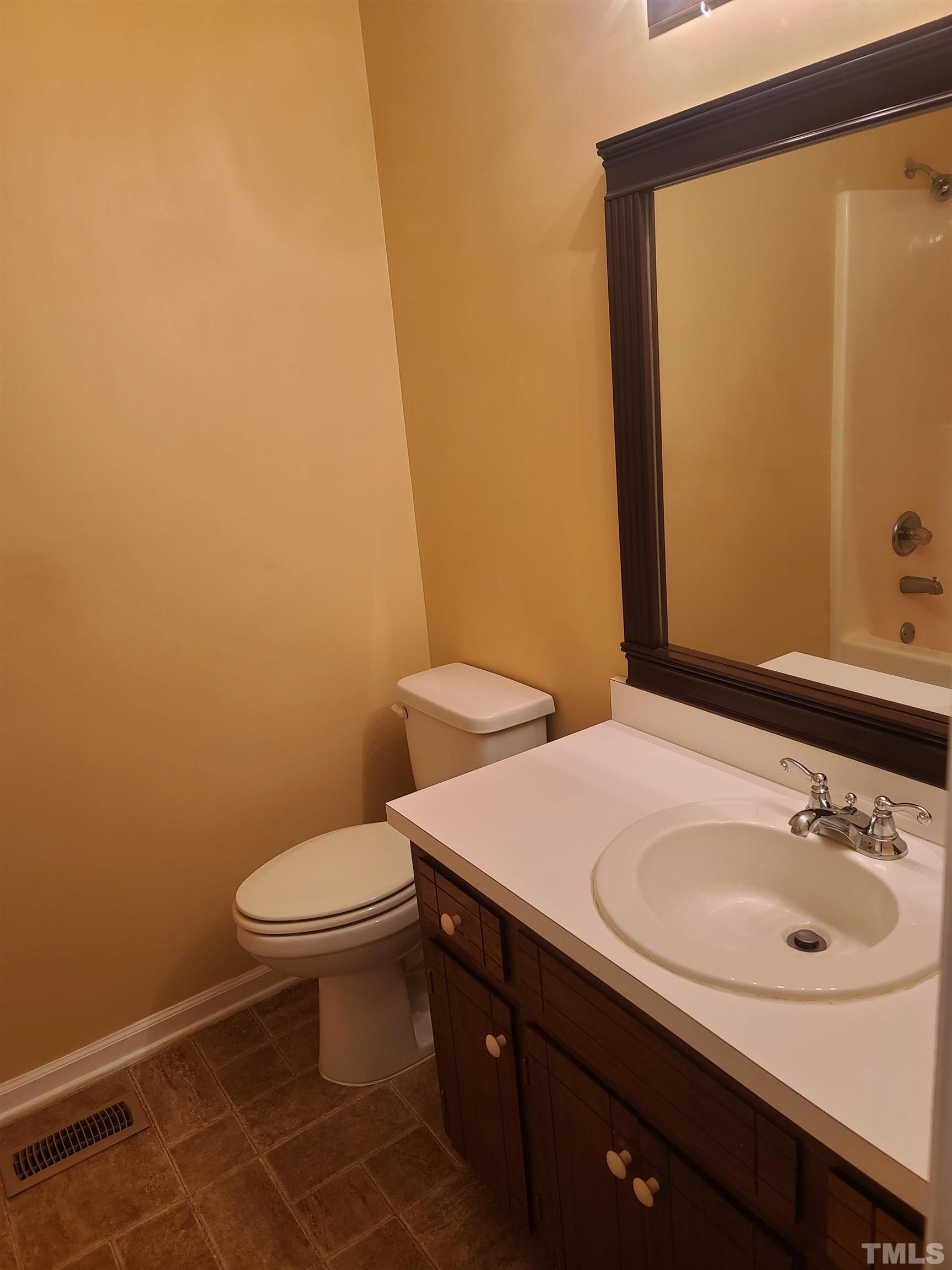 13125 Callens Lane Willow Spring, NC 27592 - Photo 9 of 13 a bathroom with a sink and a toilet