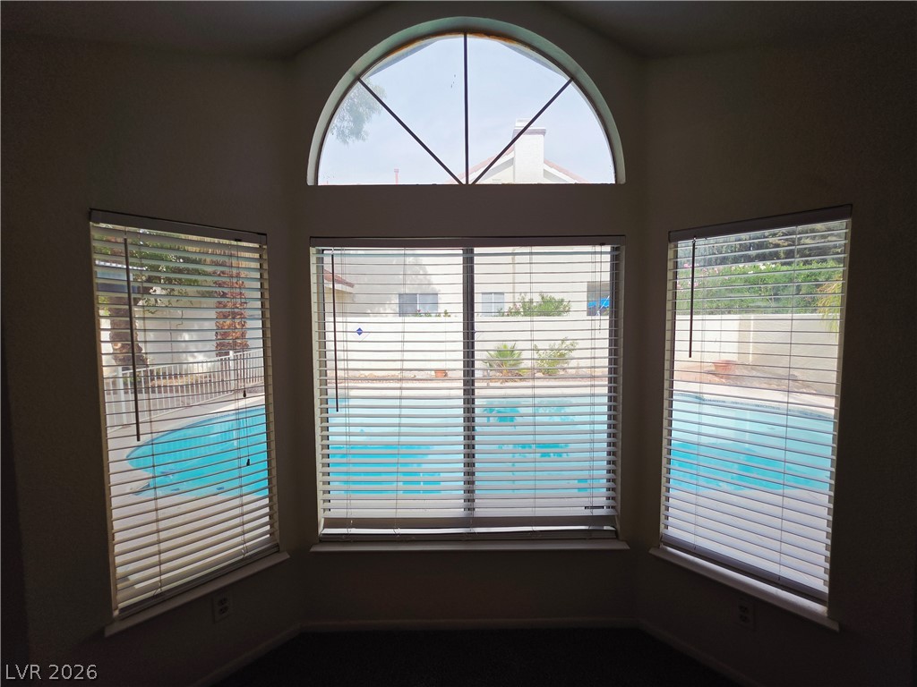 2920 Setting Sun Street Las Vegas, NV 89117 - Photo 24 of 43 This living space offers refreshing pool views through elegant windows.