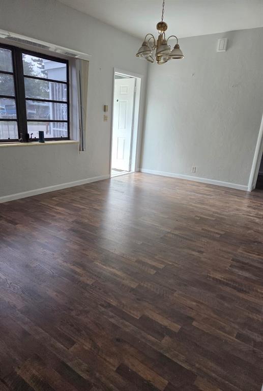 31 Edmund Road, Unit 1 West Park, FL 33023 - Photo 2 of 9 an empty room with wooden floor chandelier fan and windows