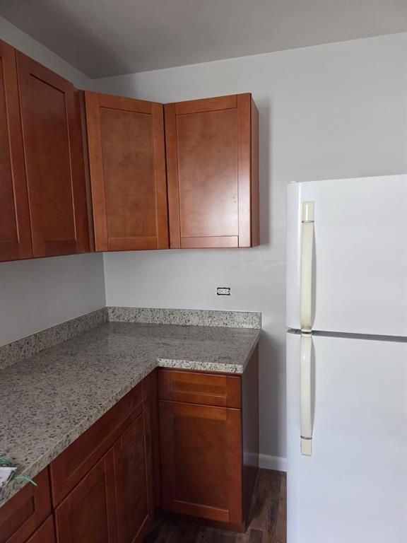 31 Edmund Road, Unit 1 West Park, FL 33023 - Photo 4 of 9 a kitchen with granite countertop cabinets stainless steel appliances and a counter space