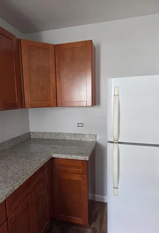 a kitchen with stainless steel appliances granite countertop a refrigerator and a sink