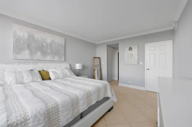 a bedroom with a bed and painting on the wall