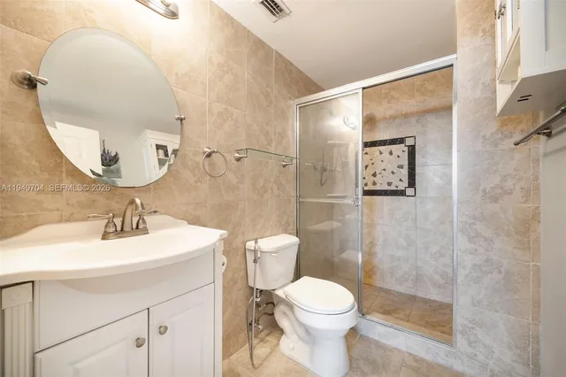 a bathroom with a toilet sink and a mirror