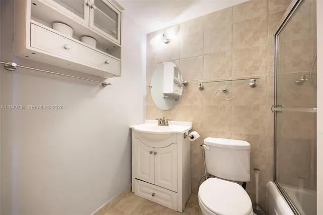 a white toilet sitting next to a bathroom sink