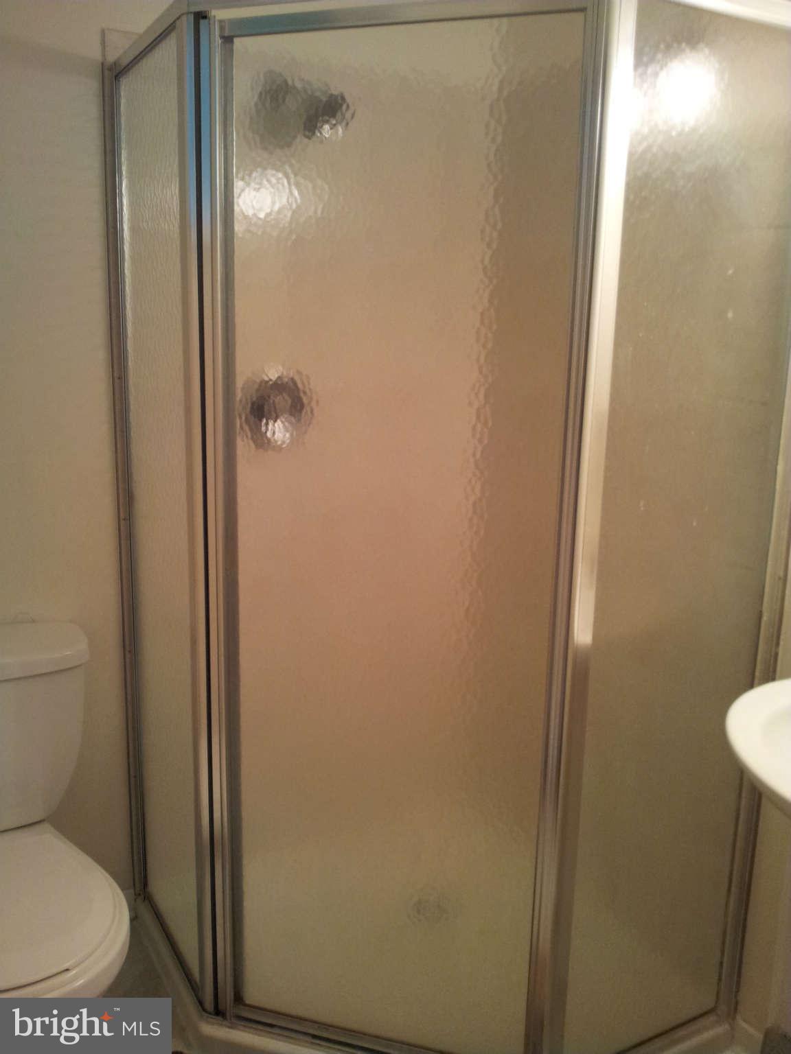 8639 Victoria Road Springfield, VA 22151 - Photo 12 of 17 a bathroom with a toilet and a shower