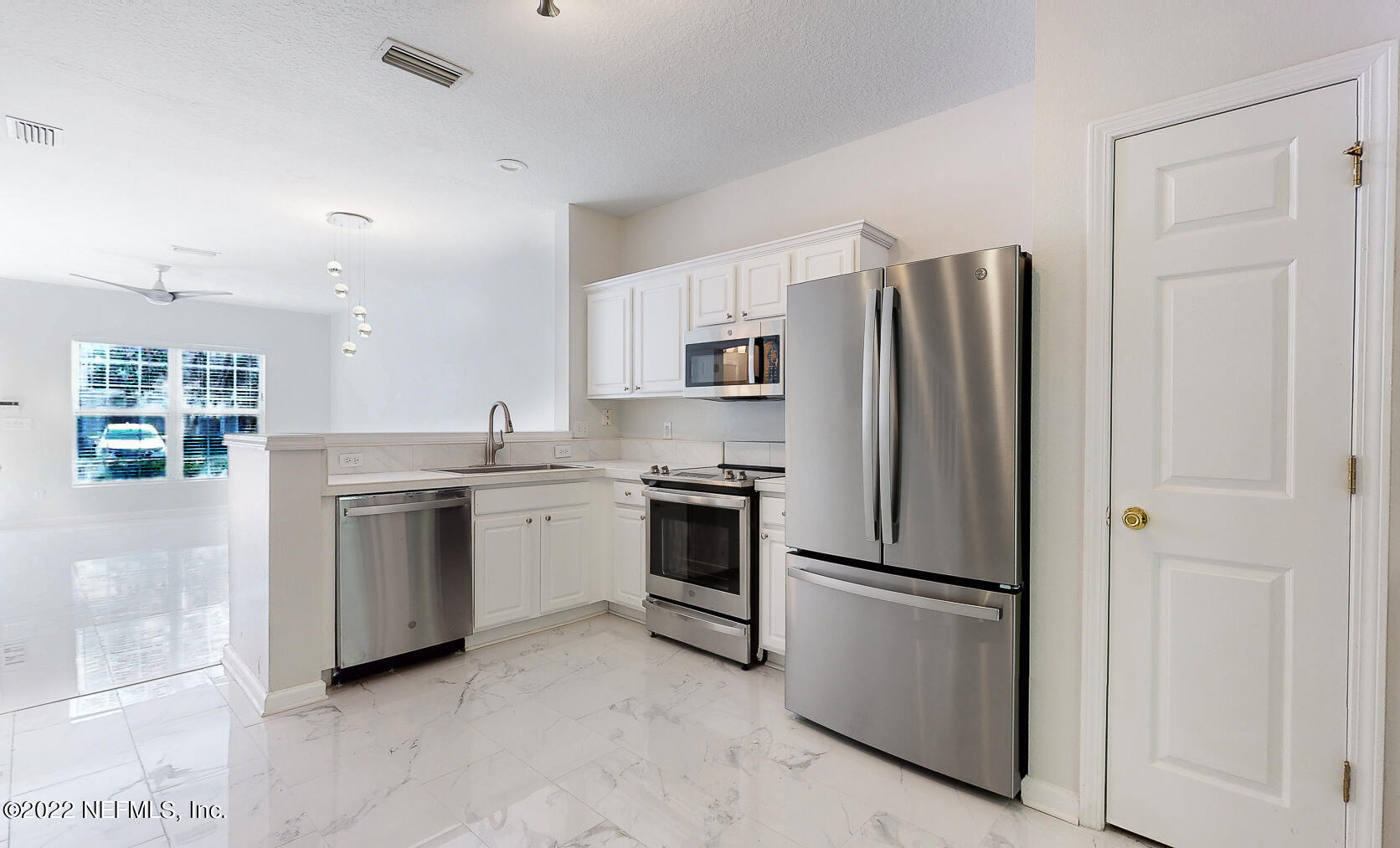 3526 Twisted Tree Lane Jacksonville, FL 32216 - Photo 1 of 33 a kitchen with a refrigerator sink and stove top oven
